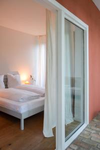 a bedroom with a bed and a large glass window at Im Scheunhornweg in Werder