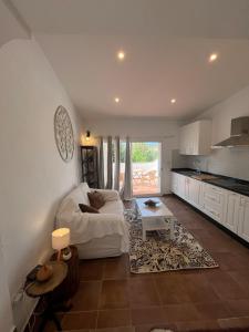 a living room with a white couch and a table at Malaka in Coín