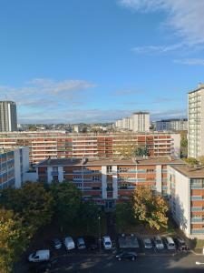 a view of a city with cars parked in a parking lot at Beautiful private room in apartment in Saint-Pierre-des-Corps