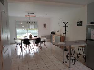 a kitchen and dining room with a table and chairs at La Maison LUDO in Arrest
