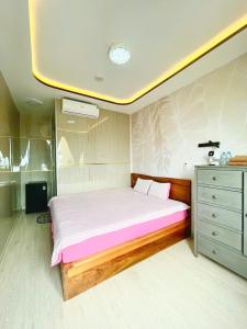 a bedroom with a large bed and a dresser at 49homestay in Ấp Khánh Phước (1)