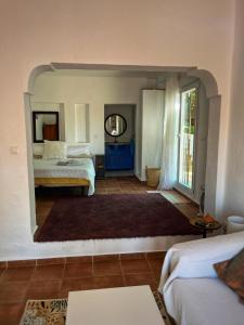 a bedroom with two beds and a large mirror at Malaka in Coín