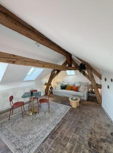 a living room with a couch and a table at Domaine à la Loëx in Geneva