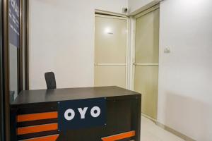 an office desk with an ovo sign on it at Hotel O EKAB Hospitality in Mundhwa