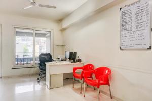 an office with red chairs and a desk with a computer at Hotel O EKAB Hospitality in Mundhwa