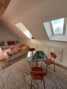 a bedroom with a bed and a table and chairs at Domaine à la Loëx in Geneva