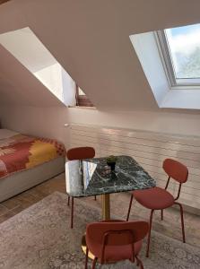 a room with a table and two chairs and a bed at Domaine à la Loëx in Geneva +8 photos
