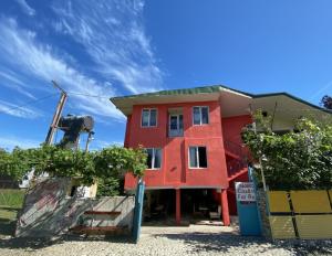 a red building with a sign in front of it at TA-mari in Ureki