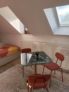 a room with a table and two chairs and a bed at Domaine à la Loëx in Geneva