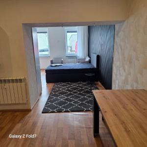 a bedroom with a bed and a table in a room at Ferienwohnung in Bexbach