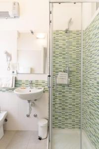 a bathroom with a sink and a shower at The Sea Hotel in Rimini