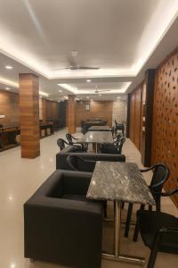 a waiting area with tables and chairs in a room at KSP Royal Valley View Hotel at Mall Road with Parking, Mussoorie in Mussoorie
