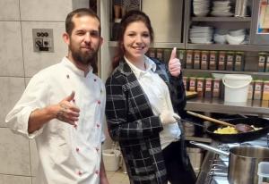 a man and woman giving thumbs up in a kitchen at pfefferHÄUSL in Regen