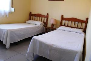 Ένα ή περισσότερα κρεβάτια σε δωμάτιο στο Global Immo 2217 Roc Mar 33B