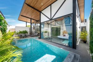 an external view of a house with a swimming pool at Sunset Garden 16 - Eco Design Villa with Private Pool near Nai Harn Beach in Rawai Beach