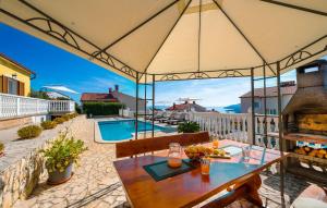 a patio with a table and a swimming pool at Cozy Apartment In Rabac With Wifi in Rabac