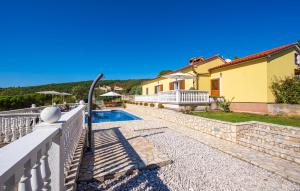 a villa with a swimming pool and a house at Cozy Apartment In Rabac With Wifi in Rabac +45 photos