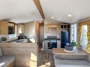 a kitchen and living room in a tiny house at Waterside Lodge in Tunstall