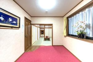 a hallway with a pink carpet and a window at TSURUNOYA The only private lodging in Tokyo Japanese TATAMI style 8 minutes walk from station FREE Parking NEW OPEN ASAKUSA AKIHABARA SKYTREE nearby in Tokyo +47 photos