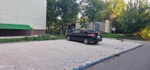 a small black car parked in a parking lot at Studio 36 in Călăraşi