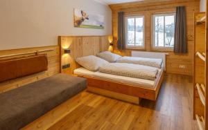 a small bedroom with a bed and a window at Bergwiesenalm in Buntenbock