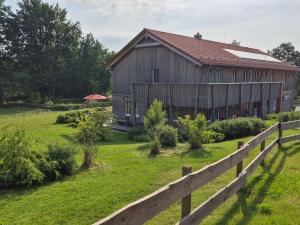 an old barn with a fence in front of it at Bergwiesenalm in Buntenbock