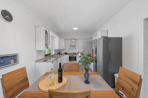 a kitchen with a table with bottles and flowers on it at House Martina in Labin