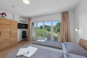 a bedroom with two beds and a large window at House Martina in Labin +52 photos