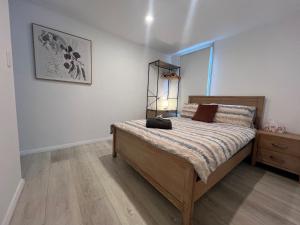 a bedroom with a bed and a dresser in it at Rustic PepperTree Views in Rockingham