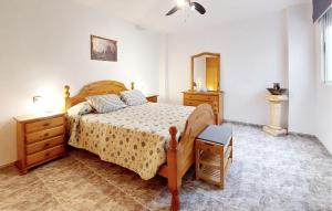 a bedroom with a bed and a dresser and a mirror at 2 Bedroom Lovely Apartment In Vinaroz in Vinaròs