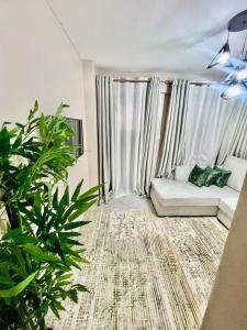 a living room with a couch and some plants at Oak South Gardens-South B in Nairobi