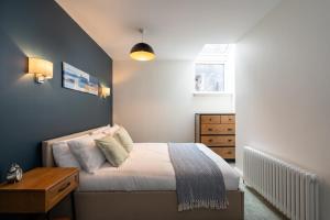 Un dormitorio pequeño con una cama y una cómoda. en Stunning upper villa stay in the City!, en Edimburgo