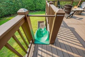 a green lawn mower sitting on a deck at Mountain Cabin Escape Views Games & Relaxation in Mineral Bluff