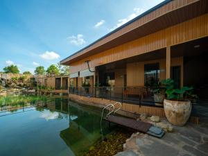 a building with a pool of water next to it at Hilltop Chill Homestay Mui Ne in Mui Ne