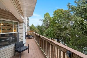 a balcony with a chair on a house at Restful Retreat - 2BDR for 6 in Kimberling City