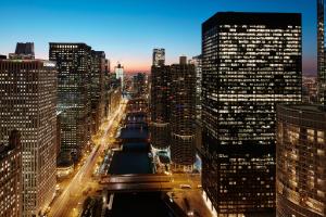 a view of a city at night with tall buildings at River Hotel in Chicago