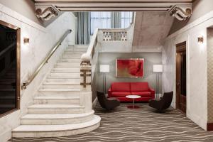 a staircase with a red couch and a red chair at River Hotel in Chicago