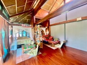 an attic bedroom with a bed and a living room at Ha Giang Uphill Coffee Farmstay in Ha Giang +48 photos