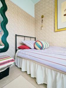 a bedroom with a bed with pillows on it at House of Agnes in Yeovil