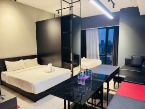 a bedroom with two beds and a table with drinks on it at Axon Residence KL in Kuala Lumpur +22 photos