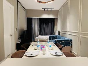 a room with a table and chairs and a bed at Axon Residence KL in Kuala Lumpur