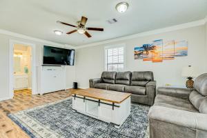 a living room with two couches and a ceiling fan at Ultimate Canal Front Game Room Boat Ramp in Crystal Beach