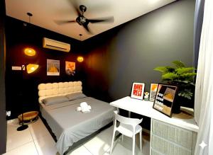 a bedroom with a bed and a desk with a ceiling at Zeva Residence Seri Kembangan 2BR in Seri Kembangan