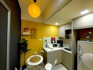a small kitchen with a small table and a sink at Zeva Residence Seri Kembangan 2BR in Seri Kembangan