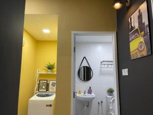a bathroom with a sink and a toilet and a mirror at Zeva Residence Seri Kembangan 2BR in Seri Kembangan +14 photos