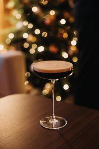 a stool sitting on a table in front of a christmas tree at Hotel GRACE LA MARGNA ST MORITZ in St. Moritz