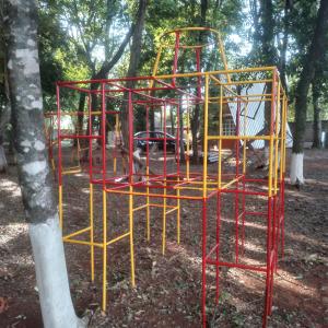 a red and yellow playground in a park at CHALET L&M Campestre in Foz do Iguaçu
