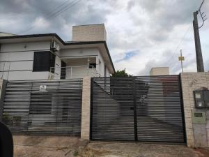 a fence in front of a house at Residência Europa in Cacoal
