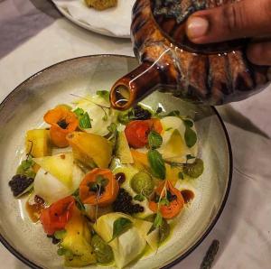 a plate of food with vegetables on a table at The Rustic Residence - Fine Culinary Experience - TRR6 in Pointe aux Canonniers
