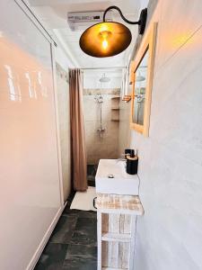 a small bathroom with a sink and a mirror at The Rustic Residence - Fine Culinary Experience - TRR6 in Pointe aux Canonniers